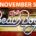The Beach Boys logo on a faded wooden flag featuring the concert date of November 5th, 2023